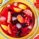 Top view on glass jug with homemade fruit berry drink with ice cubes on yellow background Top view on glass jug with homemade fruit berry drink with ice cubes on yellow background - PhotoDune Item for Sale
