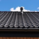 Dark tiled roof providing building ventilation against blue sky Dark tiled roof providing building ventilation against blue sky - PhotoDune Item for Sale