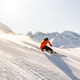 Skier Gliding on a Sunny Piste in Austria Skier Gliding on a Sunny Piste in Austria - PhotoDune Item for Sale