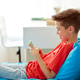 happy smiling boy with smartphone at home happy smiling boy with smartphone at home - PhotoDune Item for Sale