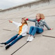 Two schoolmates relax and have fun on concrete embankment. Two schoolmates relax and have fun on concrete embankment. - PhotoDune Item for Sale