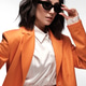 Spectacular beautiful woman in a trendy orange suit with classic make-up. Beauty face. Spectacular beautiful woman in a trendy orange suit with classic make-up. Beauty face. - PhotoDune Item for Sale