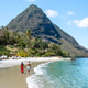 Couple enjoying a romantic stroll along the pristine beach in Saint Lucia tropical paradise Couple enjoying a romantic stroll along the pristine beach in Saint Lucia tropical paradise - PhotoDune Item for Sale