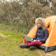 Curly and blonde hair, mountaineer woman camps with his orange tent, teleworking with his laptop Curly and blonde hair, mountaineer woman camps with his orange tent, teleworking with his laptop - PhotoDune Item for Sale
