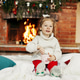 Little girl sitting on Christmas or New Year's eve at home Little girl sitting on Christmas or New Year's eve at home - PhotoDune Item for Sale