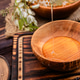 Nectar drips from a wooden spoon into a bowl surrounded by blooming flowers and honey Nectar drips from a wooden spoon into a bowl surrounded by blooming flowers and honey - PhotoDune Item for Sale