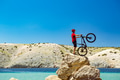 Mountain biker looking at mountains and beach Mountain biker looking at mountains and beach - PhotoDune Item for Sale