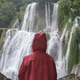 waterfall person iceland looking Seljalandsfoss waterfall person iceland looking Seljalandsfoss - PhotoDune Item for Sale