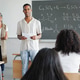 High School Student Presenting Science Project in Front of Classroom with Teacher High School Student Presenting Science Project in Front of Classroom with Teacher - PhotoDune Item for Sale
