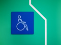 Disabled Parking, Disability symbol paint on green wall Disabled Parking, Disability symbol paint on green wall - PhotoDune Item for Sale