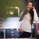 Pregnant woman smiling warmly while resting in a cozy kitchen setting Pregnant woman smiling warmly while resting in a cozy kitchen setting - PhotoDune Item for Sale