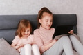 Two little girls sisters sitting in bedroom, holding gadgets. Kids using technologies at home Two little girls sisters sitting in bedroom, holding gadgets. Kids using technologies at home - PhotoDune Item for Sale