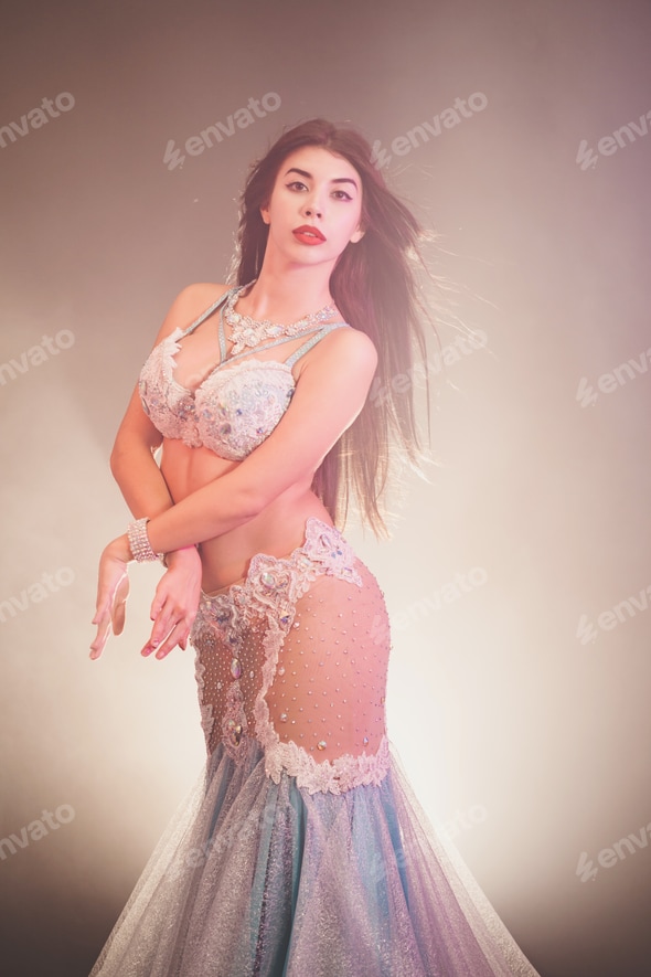 adorable sexy traditional oriental belly dancer girl dancing on luminous smoke background Stock Photo by Kohanova adorable sexy traditional oriental belly dancer girl dancing on luminous smoke background Stock Photo by Kohanova