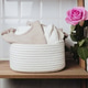 New baby clothes in white rope basket with rose on wooden shelf. New baby clothes in white rope basket with rose on wooden shelf. - PhotoDune Item for Sale