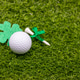 Golf ball is on green grass for St. Patrick's Day Golf ball is on green grass for St. Patrick's Day - PhotoDune Item for Sale