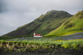 Church on a hill next to mountains in Vik, Iceland Church on a hill next to mountains in Vik, Iceland - PhotoDune Item for Sale