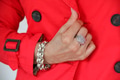 Closeup view of woman wearing red coat and hand in view with silver ring and bracelet accessories. Closeup view of woman wearing red coat and hand in view with silver ring and bracelet accessories. - PhotoDune Item for Sale