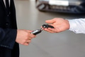 Car salesman gives the keys to the customers who signed the purchase contract Car salesman gives the keys to the customers who signed the purchase contract - PhotoDune Item for Sale