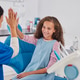 Little happy girl gives a high five to a pediatric dentist Little happy girl gives a high five to a pediatric dentist - PhotoDune Item for Sale