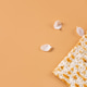 Spring flowers and matzo bread on beige background. Spring flowers and matzo bread on beige background. - PhotoDune Item for Sale