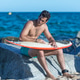 Serious man sitting on rocks with surfboard. Serious man sitting on rocks with surfboard. - PhotoDune Item for Sale