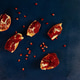 ripe pomegranate broken into pieces on blue wooden background ripe pomegranate broken into pieces on blue wooden background - PhotoDune Item for Sale