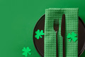 Festive table setting with St Patrick's Day green decoration on green background. Festive table setting with St Patrick's Day green decoration on green background. - PhotoDune Item for Sale