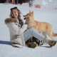 A woman in a jacket sits in the snow and hugs her pet A woman in a jacket sits in the snow and hugs her pet - PhotoDune Item for Sale