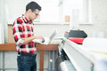 Man with laptop working in printing office Man with laptop working in printing office - PhotoDune Item for Sale