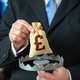 A businessman is holding the British pound in a trap. A financial trap, risk of fraud A businessman is holding the British pound in a trap. A financial trap, risk of fraud - PhotoDune Item for Sale