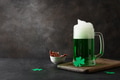 Patrick's day green beer in pint on black background. Copy space. Close up. Shamrock symbol of luck. Patrick's day green beer in pint on black background. Copy space. Close up. Shamrock symbol of luck. - PhotoDune Item for Sale
