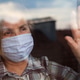 Portrait of elderly senior citizen wearing face mask looking through room window Portrait of elderly senior citizen wearing face mask looking through room window - PhotoDune Item for Sale