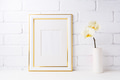 Gold decorated frame mockup with soft yellow orchid in vase Gold decorated frame mockup with soft yellow orchid in vase - PhotoDune Item for Sale