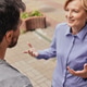 Lively discussion occurs outside as adult male with a hearing aid joyfully connects Lively discussion occurs outside as adult male with a hearing aid joyfully connects - PhotoDune Item for Sale