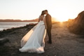 Just married couple kissing near the ocean Just married couple kissing near the ocean - PhotoDune Item for Sale