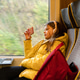 Teenager girl in a yellow jacket with headphones on her head sitting in a suburban train watching a Teenager girl in a yellow jacket with headphones on her head sitting in a suburban train watching a - PhotoDune Item for Sale