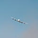 Large passenger plane is flying high in the sky, leaving a trail of white smoke behind it. Large passenger plane is flying high in the sky, leaving a trail of white smoke behind it. - PhotoDune Item for Sale