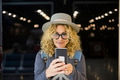 close up and portrait of beautiful curly woman looking at her phone close up and portrait of beautiful curly woman looking at her phone - PhotoDune Item for Sale