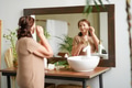 Portrait of senior woman taking care of her skin, looking at mirror Portrait of senior woman taking care of her skin, looking at mirror - PhotoDune Item for Sale