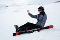 Girl dressed in ski suit and helmet seats with ski on snow and take selfie on smartphone Girl dressed in ski suit and helmet seats with ski on snow and take selfie on smartphone - PhotoDune Item for Sale