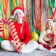 Two young girls in festive hats holding large candy canes at a holiday-themed celebration Two young girls in festive hats holding large candy canes at a holiday-themed celebration - PhotoDune Item for Sale