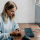 Woman works at a desk with computer and smartphone in a modern home office Woman works at a desk with computer and smartphone in a modern home office - PhotoDune Item for Sale