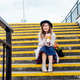 Portrait of young smiling woman with fresh tulips and coffee cup sitting on stairs at city street Portrait of young smiling woman with fresh tulips and coffee cup sitting on stairs at city street - PhotoDune Item for Sale