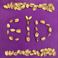 The word EID written using pistachio nuts on purple background The word EID written using pistachio nuts on purple background - PhotoDune Item for Sale