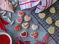 Valentines flat lay with heart shaped cookies being baked and baking utensils on gray background. Valentines flat lay with heart shaped cookies being baked and baking utensils on gray background. - PhotoDune Item for Sale