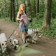 woman walks pack of dogs on leashes in a park. dog sitter, dog handler, trains pets. woman walks pack of dogs on leashes in a park. dog sitter, dog handler, trains pets. - PhotoDune Item for Sale