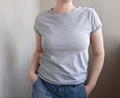 Girl wear gray comfort t-shirt standing and posing above the wall. Tee mock up Girl wear gray comfort t-shirt standing and posing above the wall. Tee mock up - PhotoDune Item for Sale
