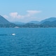 Lake Maggiore Scenic View With Motorboat Cruising Across Calm Waters And Green Hills In Italy Lake Maggiore Scenic View With Motorboat Cruising Across Calm Waters And Green Hills In Italy - PhotoDune Item for Sale
