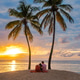 Couple enjoying a romantic sunset picnic on the beach in Saint Lucia Couple enjoying a romantic sunset picnic on the beach in Saint Lucia - PhotoDune Item for Sale