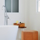 interior of modern bathroom with white bathtub and brown stool interior of modern bathroom with white bathtub and brown stool - PhotoDune Item for Sale